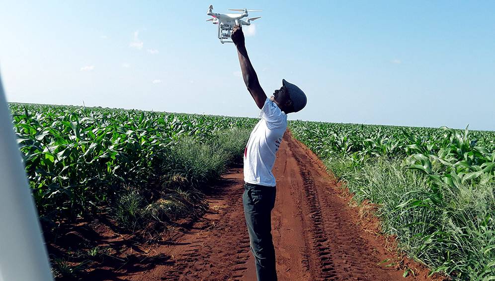 Farmer launching drone